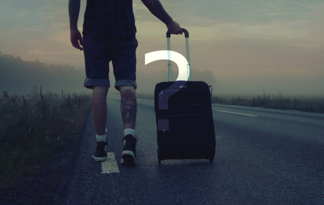 man-walking-on-the-road-holding-black-luggage-during-sunset-160483